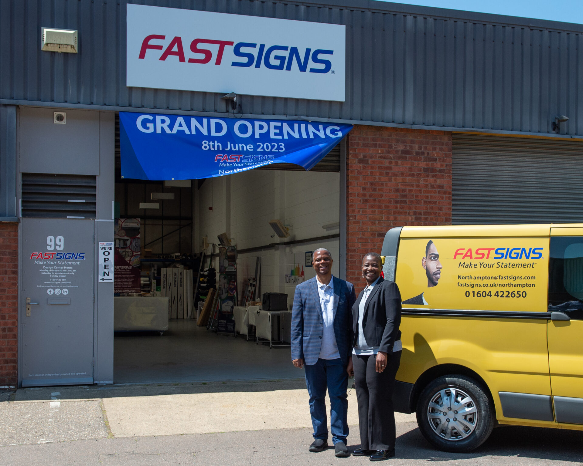 Laide and Tunde Sodipo outside FASTSIGNS Northampton at their Grand Opening event 