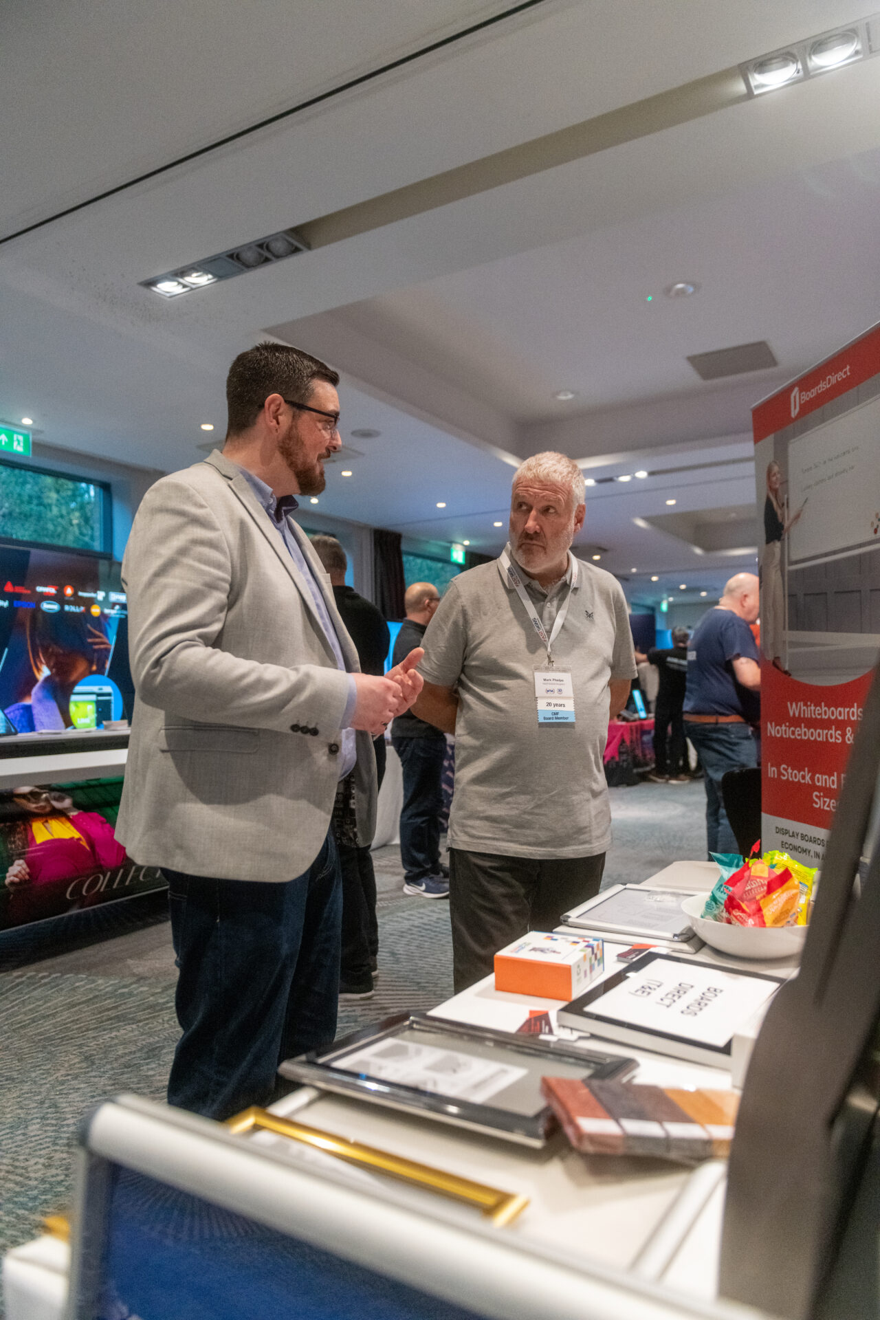 Mark in discussion with a supplier at the FASTSIGNS UK Convention in 2025. 