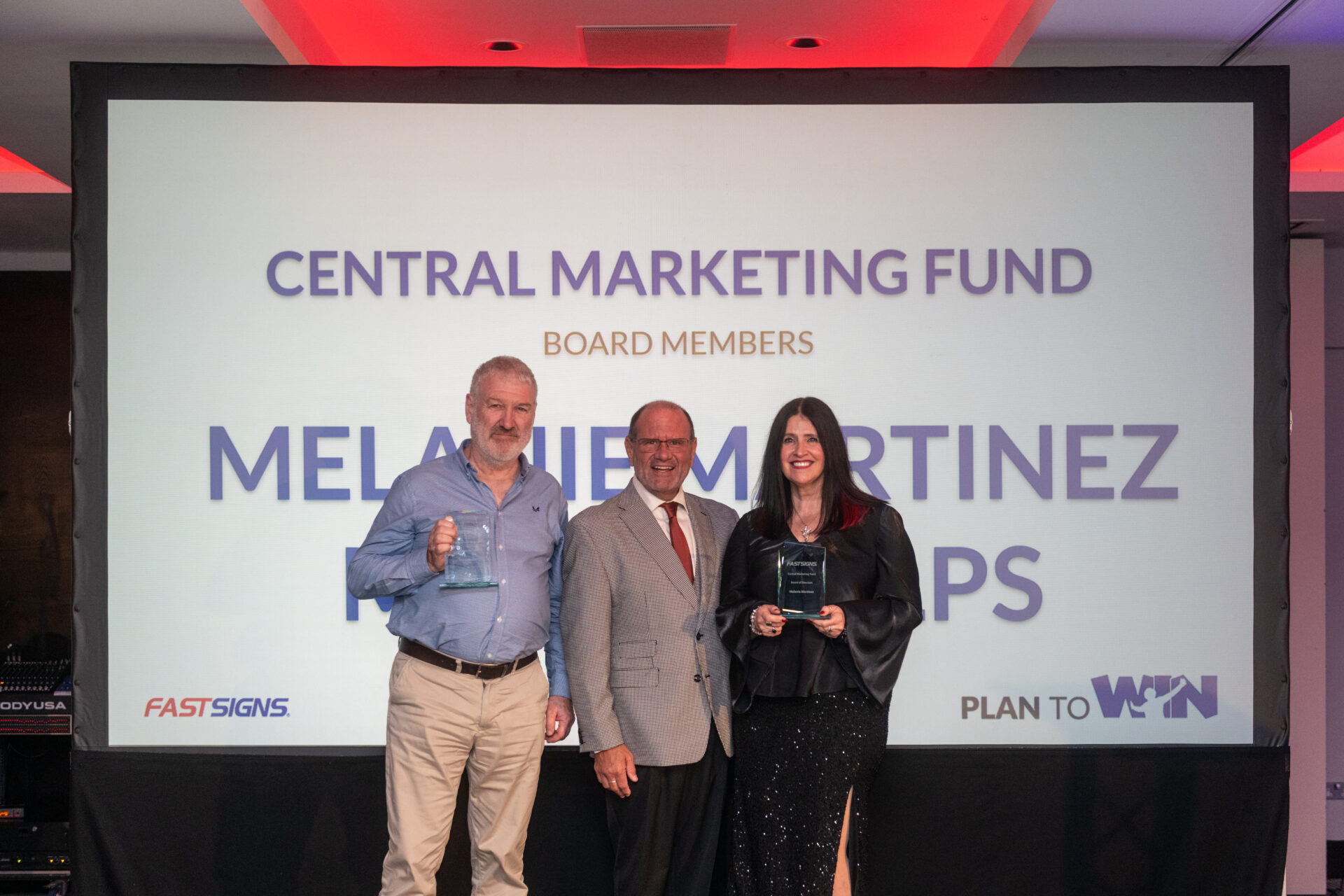 Mark Phelps collecting his award at UK Convention recognising his contribution to the Central Marketing Board, alongside Brand President, Jim Howe and Melanie Martinez 