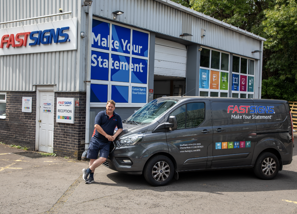 Martin Slater standing in front of the FASTSIGNS Sheffield centre and branded van